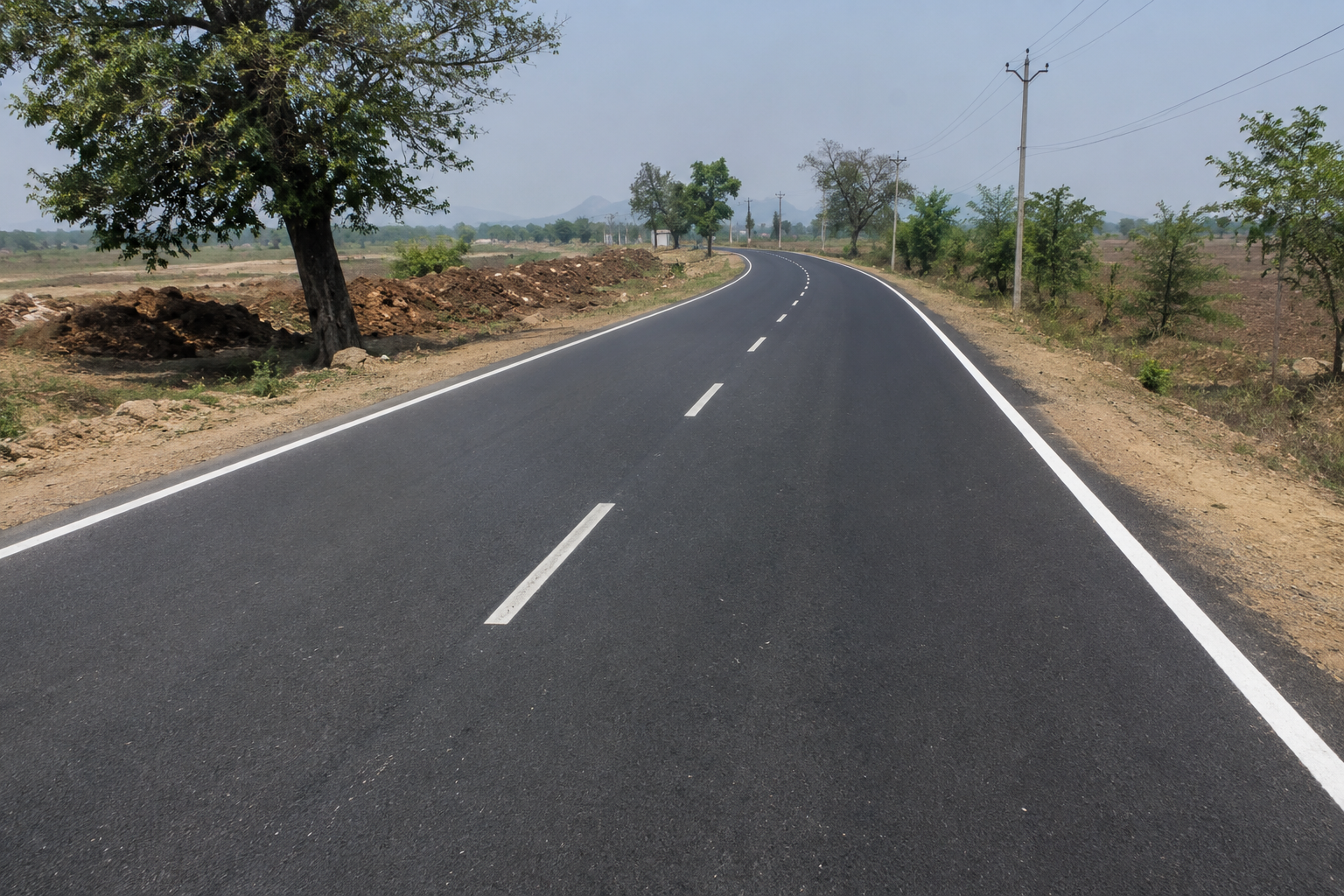 Roller compacting a bituminous road surface